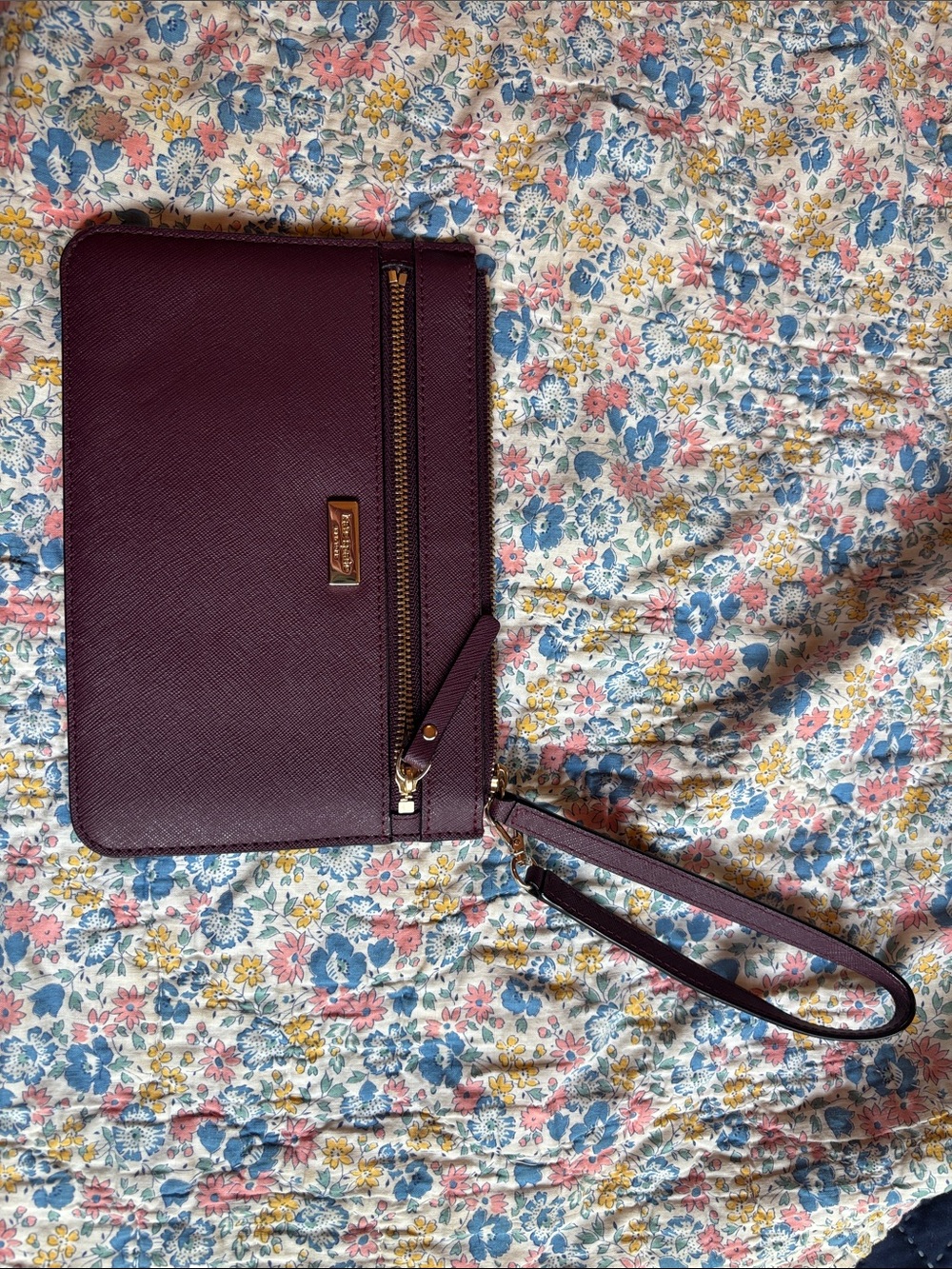kate spade deep plum Saffiano wristlet with gold hardware